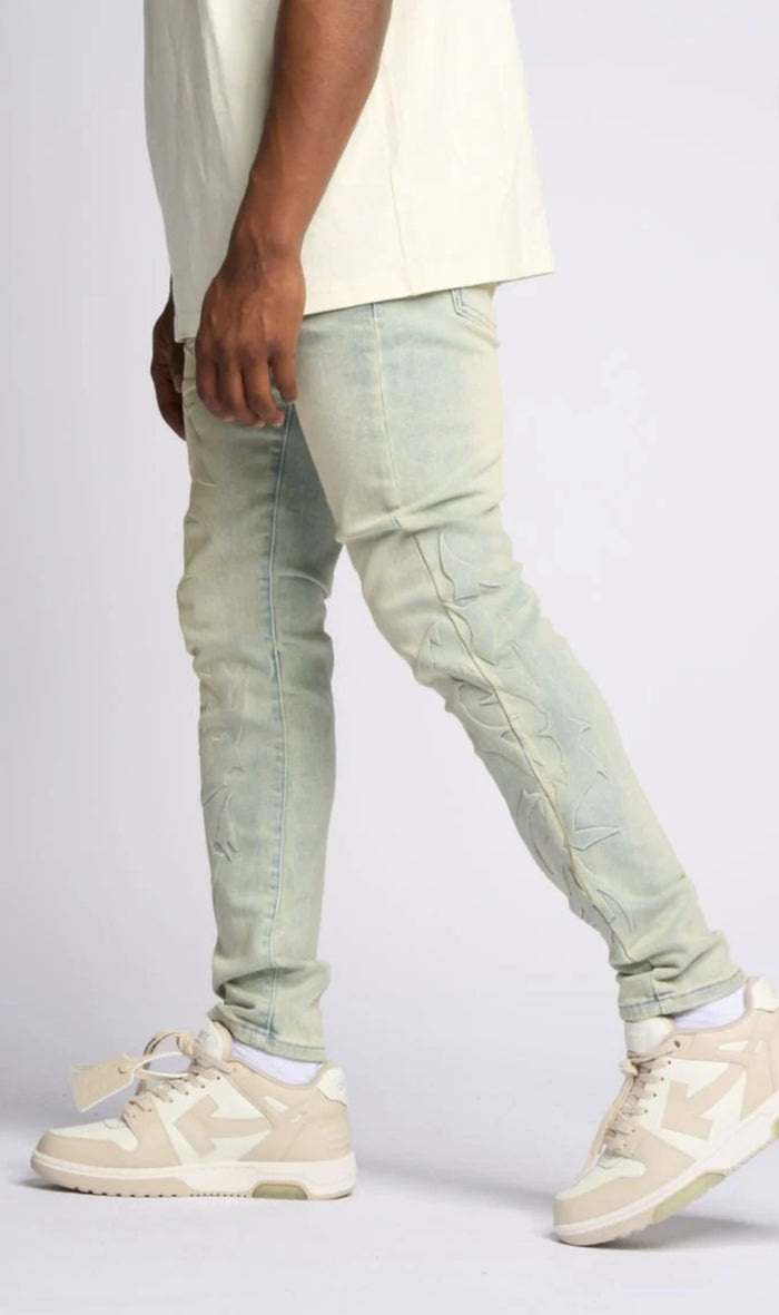 LOVE IS PAIN EMBOSSED SKINNY DENIM